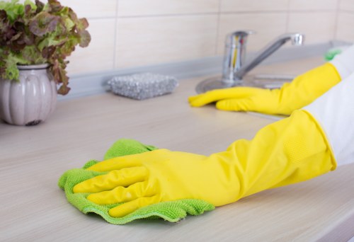 Technician treating fabric upholstery with cleaning equipment